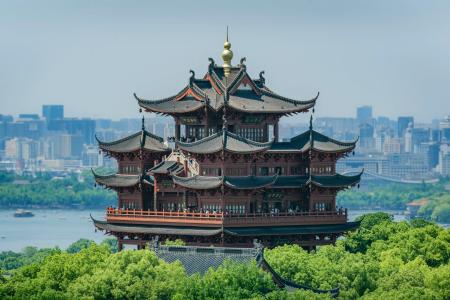 Hangzhou Chenghuang Pavilion West Lake Panoramic Scenic Tour Chenghuang Pavilion (City God Pavilion) Surrounded By Lush Green Trees Overlooking Hangzhou West Lake And Modern City Skyline