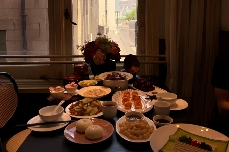 Abundant feast of classic Shanghainese cuisine laid out by the window