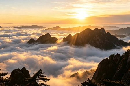 Golden sunrise over Huangshan jagged peaks above rolling sea of clouds