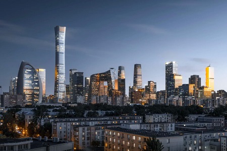 Beijing CBD skyline illuminated at dusk, featuring modern skyscrapers and high-rise buildings viewed from a residential area.