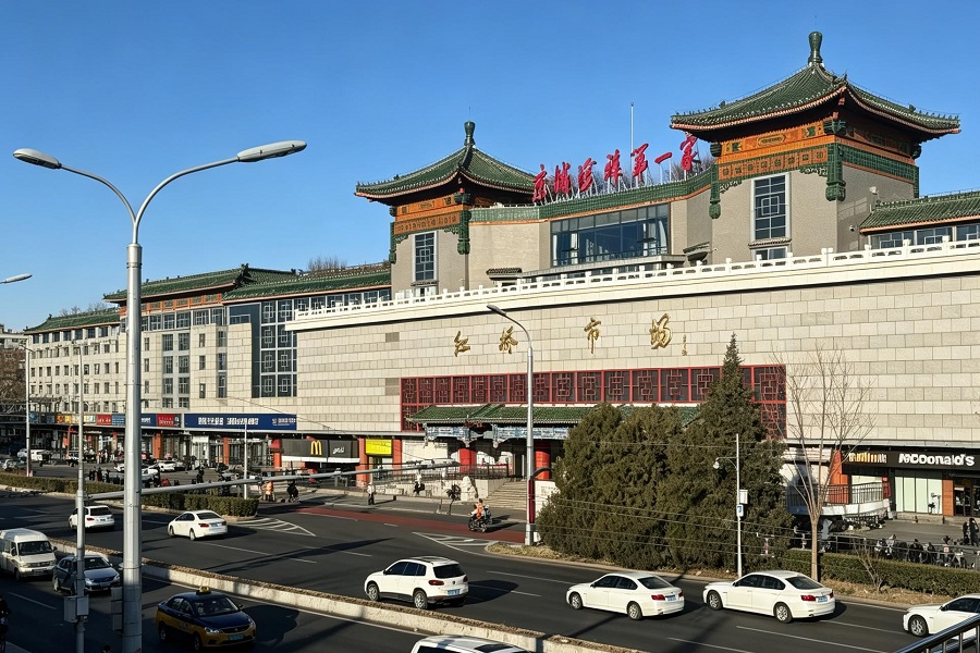 Street view of Hongqiao Market building with traditional Chinese?style roof, busy city road with traffic in Beijing