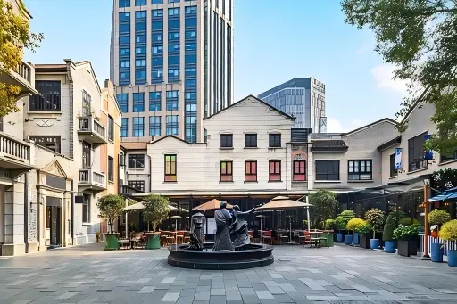 Daytime view of open plaza, fountain sculpture and shikumen buildings in Shanghai Xintiandi