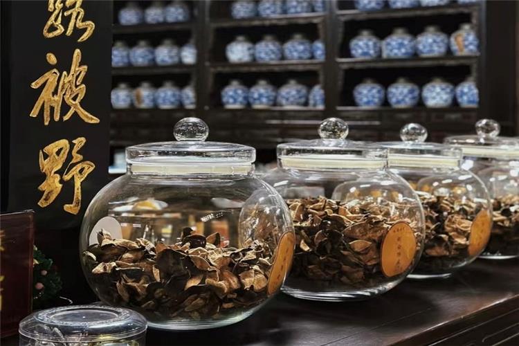 Various dried wild herbal ingredients stored in transparent glass jars, showcasing abundant raw materials of traditional Chinese medicine culture