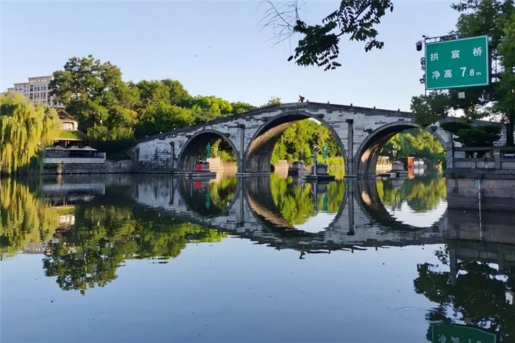 Gongchen Bridge in Hangzhou presenting grand ancient stone bridge with canal water flowing underneath