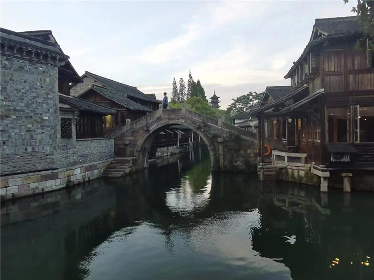Ancient Stone Bridges of Nanxun Ancient stone arch bridges in Nanxun Ancient Town featuring classic Ming and Qing stone bridge architecture mirrored in winding waterways of Jiangnan water town