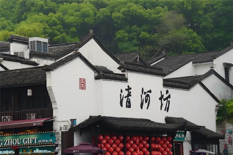 Hefang Street (Qinghefang) in Hangzhou featuring time-honored Southern Song ancient pedestrian street with antique shops, local snacks, traditional Chinese medicine stores and red lantern-lit historic architecture at the foot of Wushan Mountain