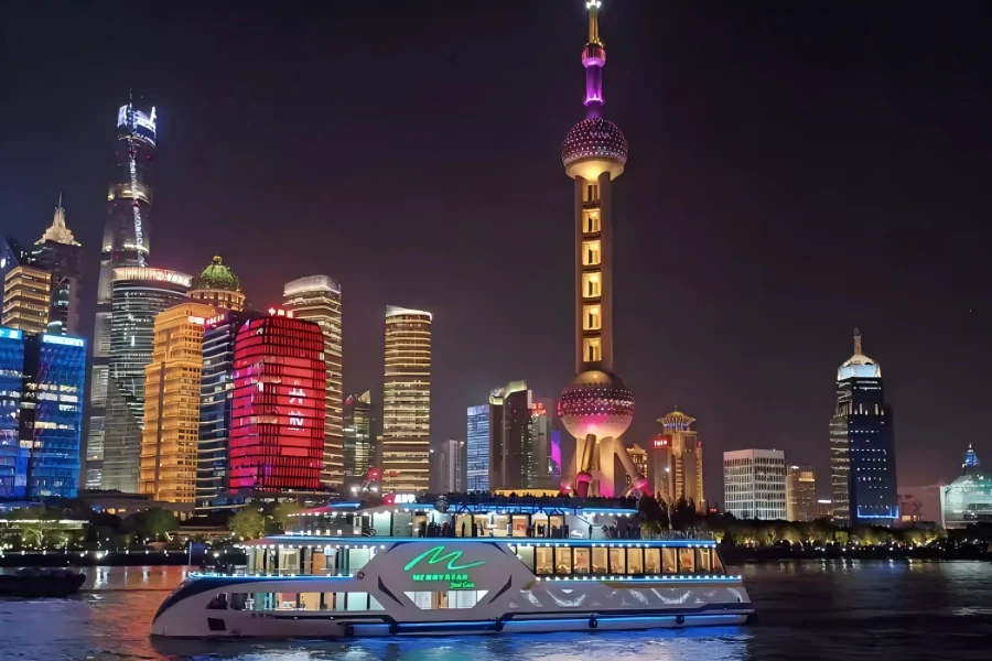 Classic Shanghai Bund Night Boat Tour The Bund Night Cruise in Shanghai showing illuminated sightseeing ships sailing on Huangpu River, with glowing colonial buildings of The Bund and dazzling Pudong skyscraper night skyline on both river banks