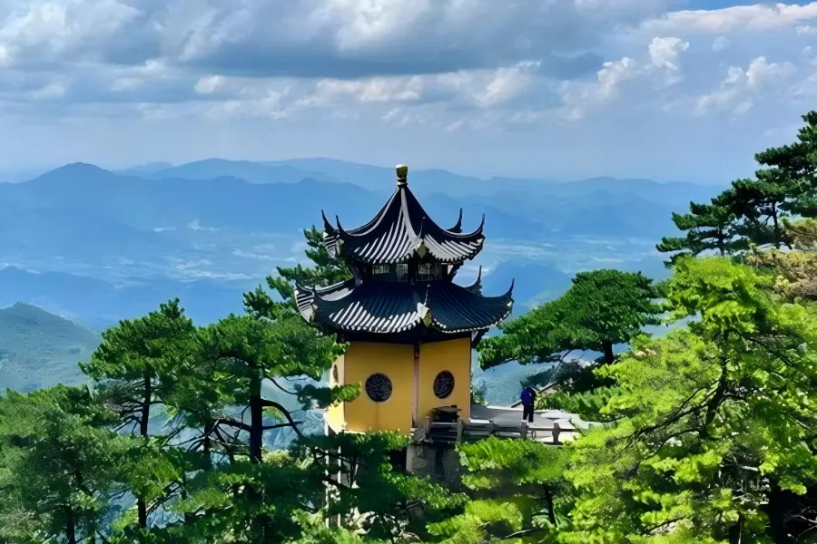 Jiuhua Mountain Great Vow Cultural Park Mount Jiuhua in Anhui featuring misty Tiantai Peak summit, winding stone hiking trails, ancient pine trees and vast rolling cloud seas rolling over the 99 lotus-shaped mountain ridges