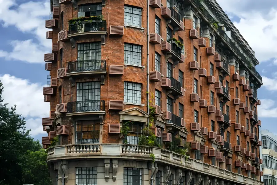 Wukang Mansion Wukang Mansion in Shanghai showcasing the iconic wedge-shaped historic apartment building at the street crossing