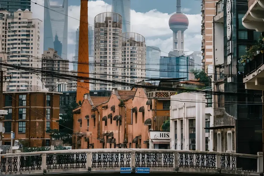 No.2 Bridge on Harbin Road No.2 Harbin Road Bridge in Shanghai showing vintage riverside factories paired with distant Lujiazui skyscrapers over Shajinggang Creek
