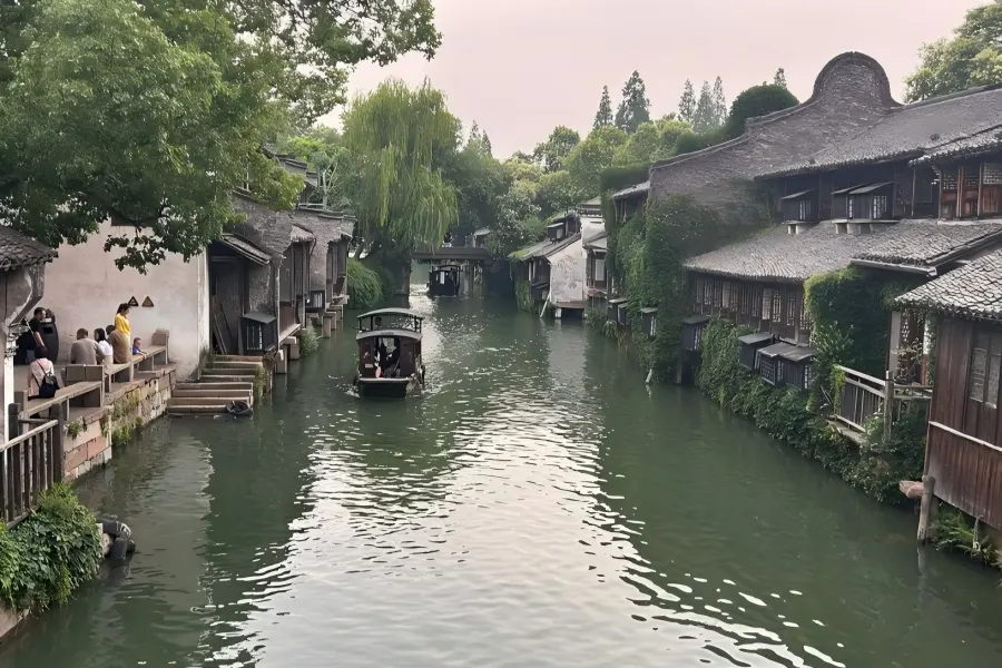 Twilight scenery of Tongli Ancient Canal lined with red lantern reflections on calm water, bluestone alleys and ancient waterfront folk dwellings of Ming and Qing styles