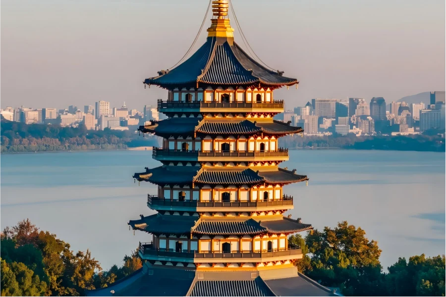 Leifeng Pagoda Leifeng Pagoda in Hangzhou overlooking shimmering West Lake under warm sunset glow