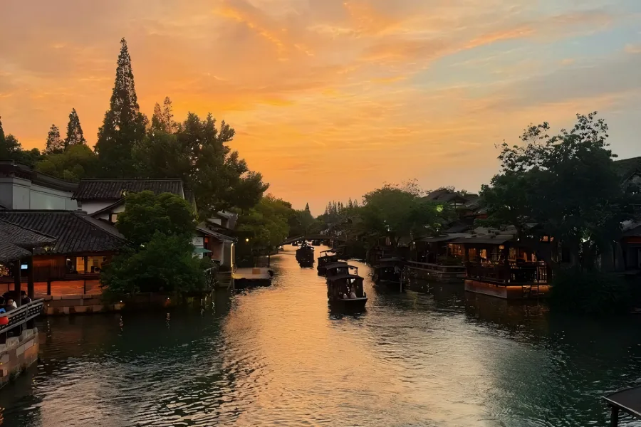 Wuzhen Jiangnan Water Town Wuzhen Water Town in Jiaxing showing classic Jiangnan canals, stone arch bridges and black-tiled waterside houses