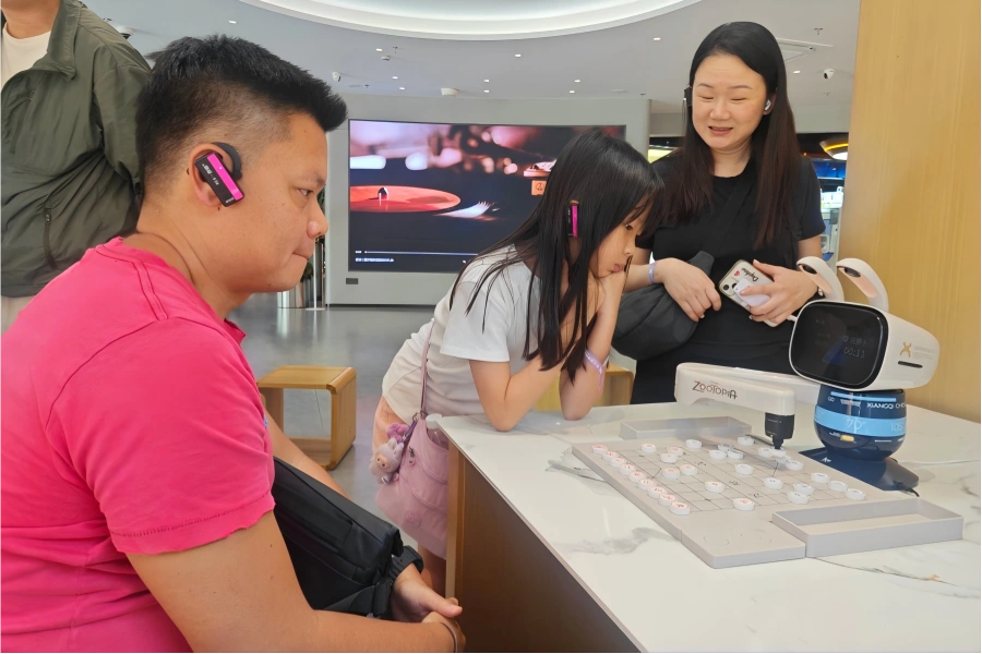 Chess Game with AI Robot at Alibaba Qinchengli Alibaba Qinchengli Experience Center in Hangzhou showing visitors playing chess with intelligent AI robot