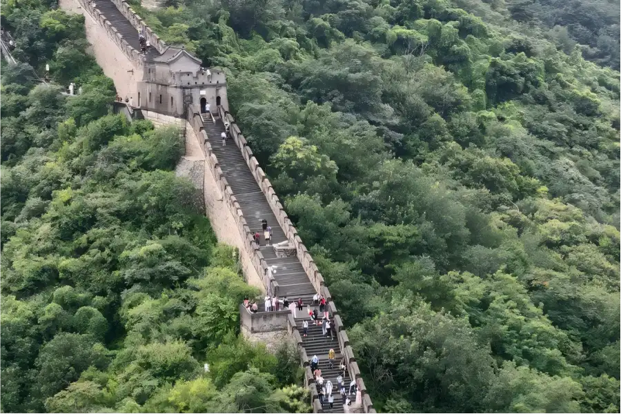 Mutianyu Great Wall in Beijing showing ancient ramparts winding along rolling green mountain ridges
