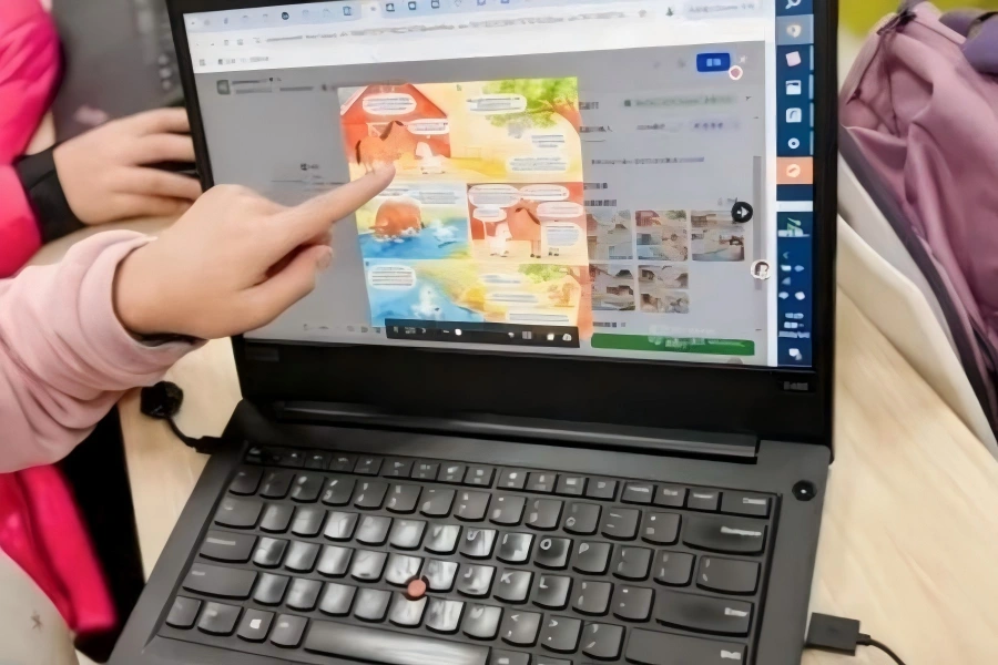 Student pointing at laptop screen for AI interactive Q&A practice