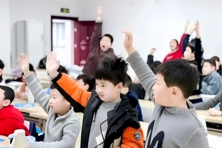 Students raising hands in study?tour classroom Young students raising hands actively during interactive study tour class
