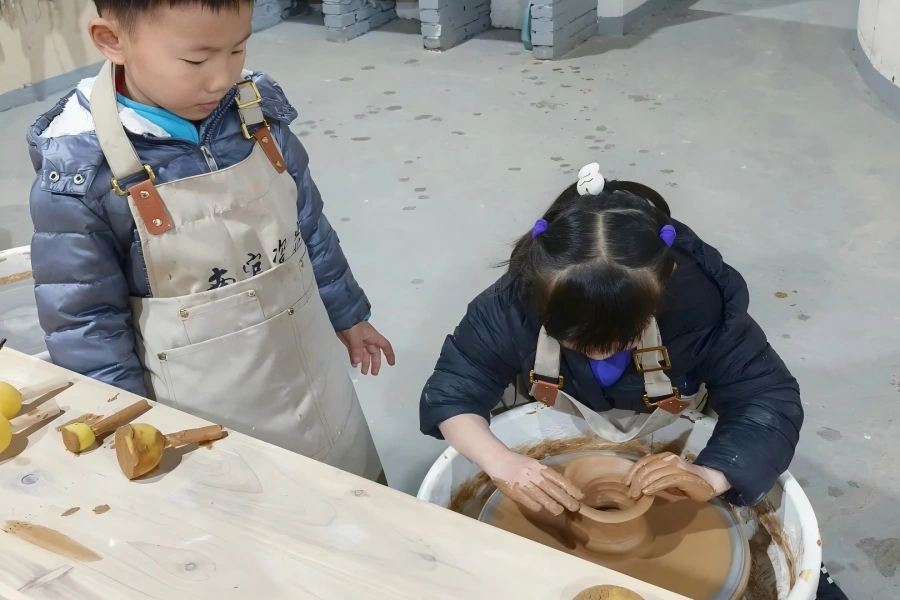 Pottery?making hands?on experience Children practicing clay throwing for pottery craft
