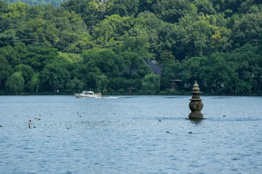 Iconic West Lake in Hangzhou, tranquil lakescape, ancient pagodas, bridges and timeless Jiangnan poetry scenery