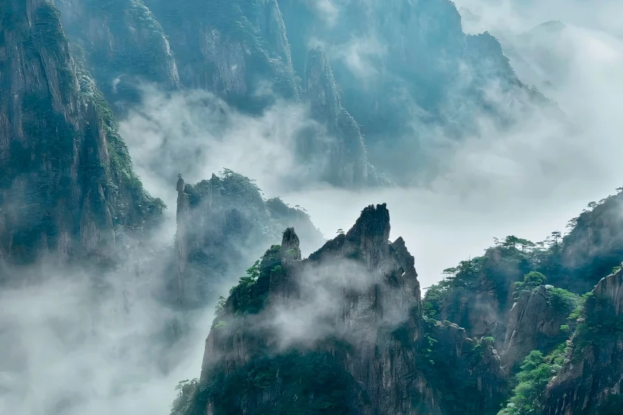 Huangshan Mountain in Anhui showing jagged granite peaks, ancient twisted pines and rolling sea of clouds