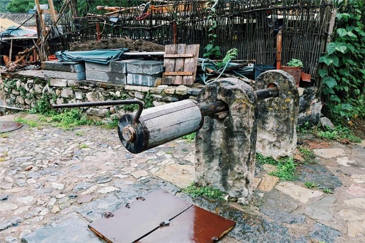 Ancient Well with Windlass in Cuanxia Village Historic stone?framed old well with manual wooden windlass in Cuanxia ancient village