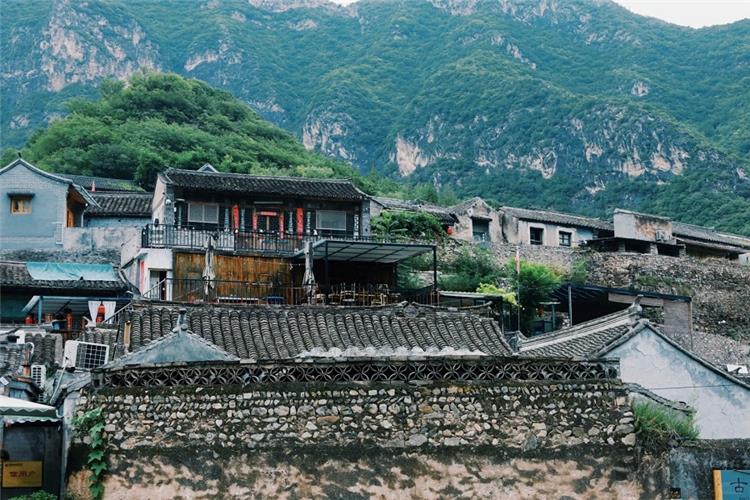 Ancient Folk Houses of Cuanxia Village Traditional stone?built courtyard houses of Cuanxia ancient village against green mountain backdrop