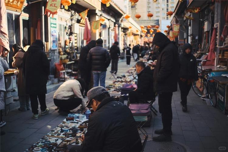 Panjiayuan Flea Market Street View Bustling street view of Panjiayuan flea market, vendors and visitors browsing antiques and handicraft stalls under red lanterns