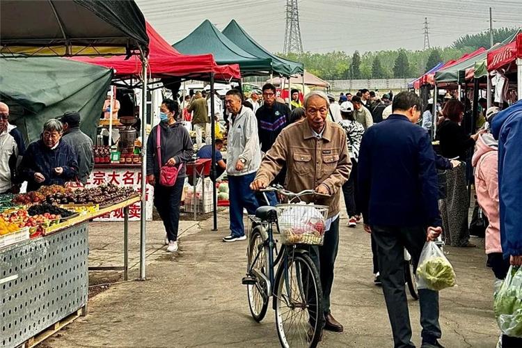Beijing Morning Market Street Scene Busy Beijing morning farmers market, local residents shopping for fresh produce, street stalls with colorful tents