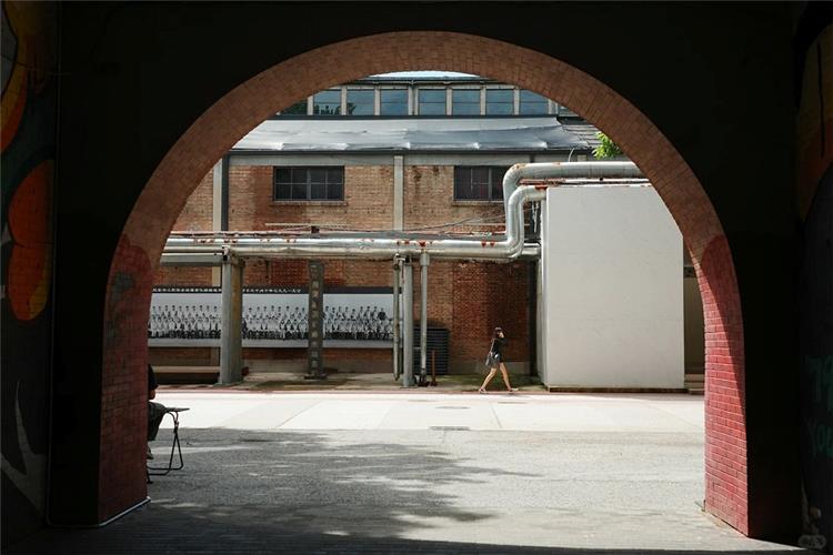 798 Art Zone Beijing Industrial Scene View through brick archway of vintage industrial brick factory buildings in 798 Art Zone, Beijing creative art district