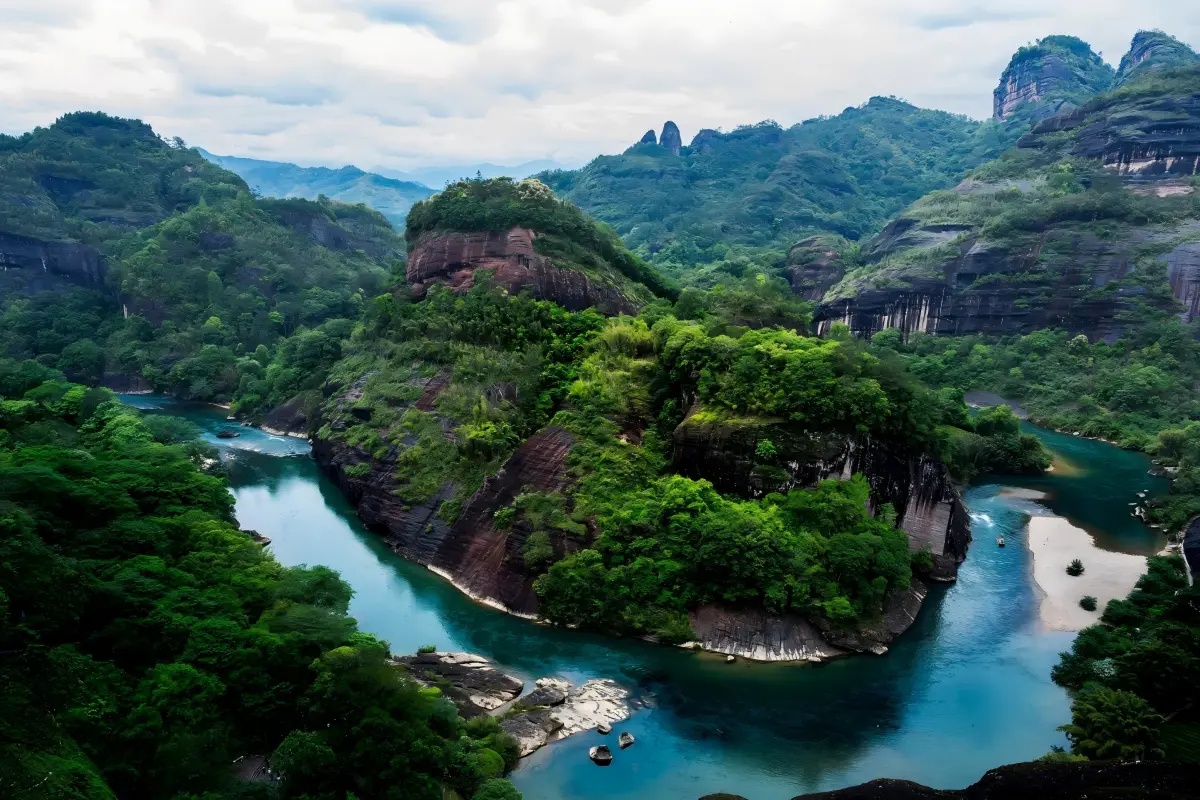 Lush green mountains and winding turquoise river in Wuyi Mountains