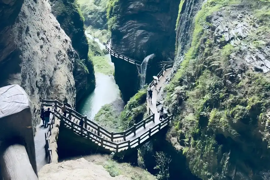 Longshuixia Fissure Gorge Scenic Spot Narrow deep canyon with towering rock walls, wooden trail and mountain streams in Wulong