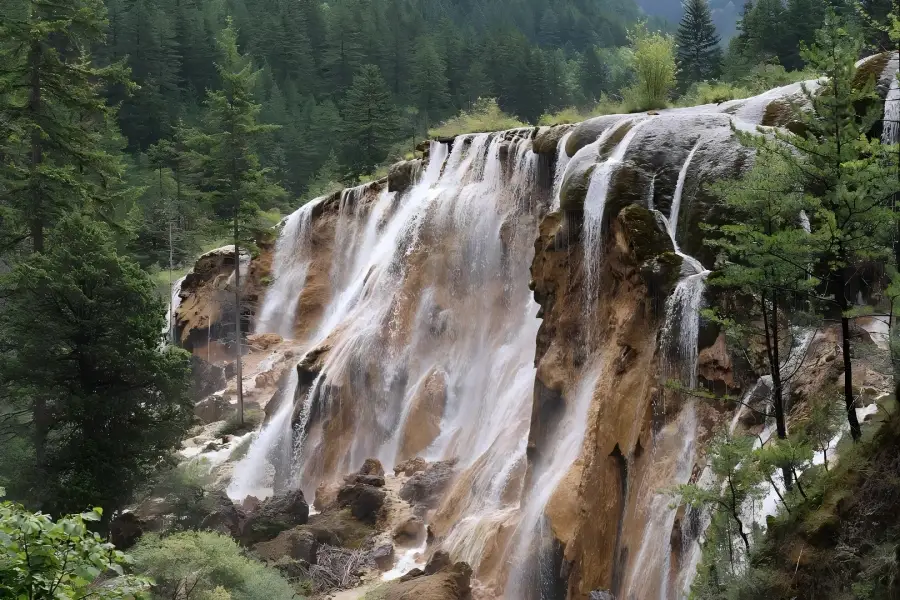 Pearl Shoal Waterfall, sparkling droplets splashing over travertine terraces, famous cascade from Jiuzhaigou natural reserve, Sichuan