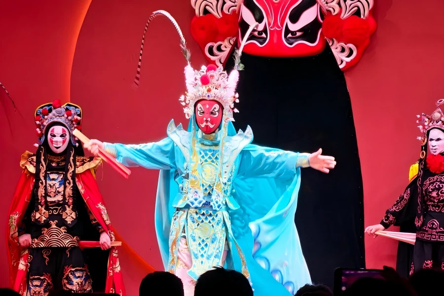 Sichuan Opera Face Changing, performer swiftly swapping vivid painted masks, intangible cultural heritage stage performance in Chengdu