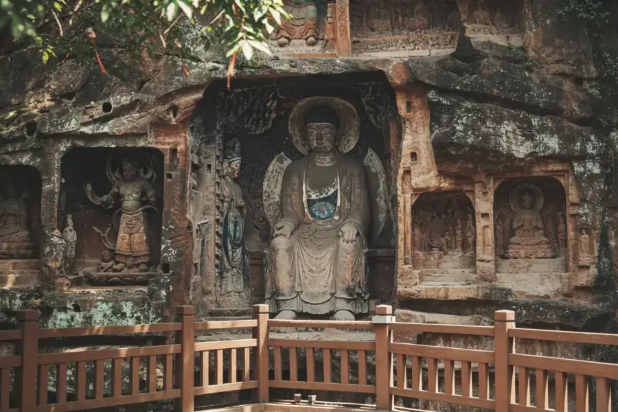 Leshan cliff grottoes with ancient Buddha carvings on red sandstone rock face