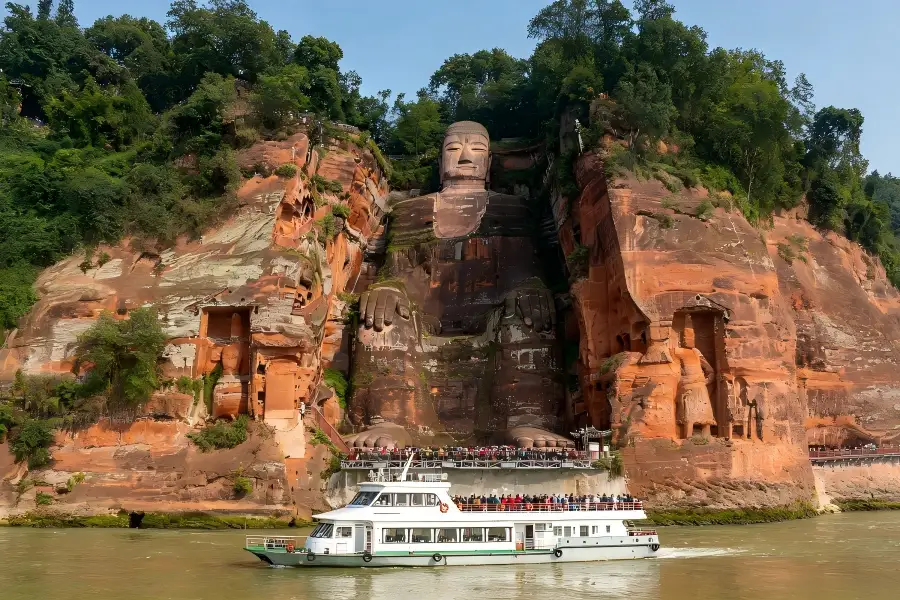 River Cruise View of Leshan Giant Buddha Leshan Giant Buddha in Leshan capturing sightseeing cruise sailing across the river for full?view of the cliff?side stone Buddha