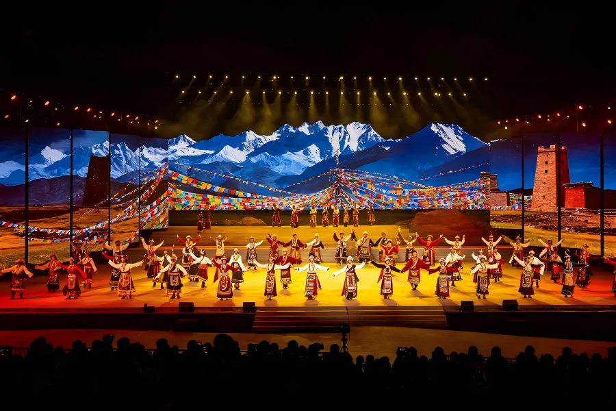 Nocturnal Tibetan?Qiang Folk Song?Dance Spectacle Tibetan?Qiang Cultural Evening Show in Aba capturing vibrant stage performance with ethnic dancers in ornate folk costumes under dramatic colourful stage lighting