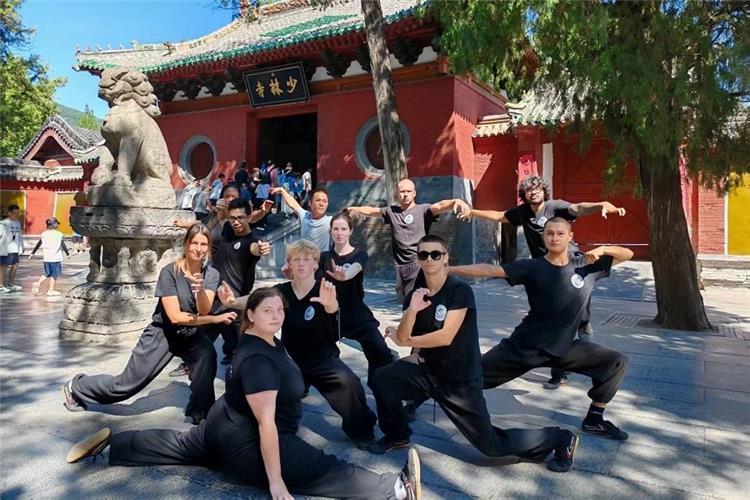 Kung Fu Group at Shaolin Gate Tour group with martial arts poses at Shaolin Temple
