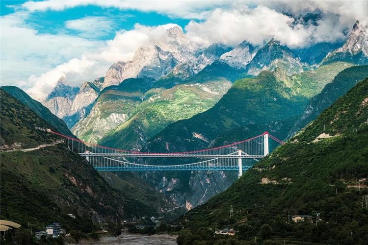 High?speed Bridge Over Tiger Leaping Gorge, Yunnan Grand suspension bridges across deep mountain gorge beneath snow?capped peaks