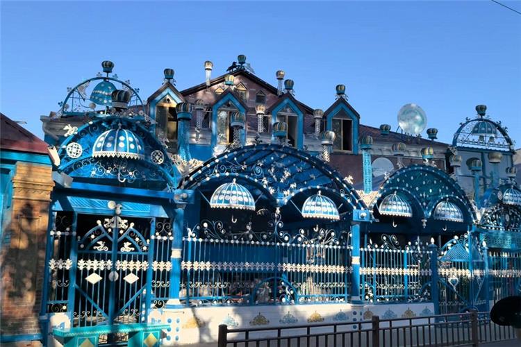 Elaborate blue?painted Russian?style folk house with iron?craft domes in Yining old town Xinjiang