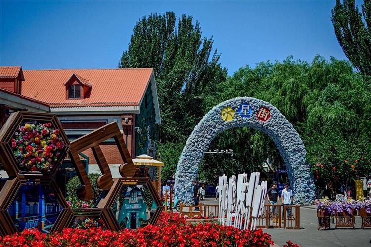Floral arch entrance of Liuxing Street Yining, colorful ethnic?style buildings and flower decorations in Xinjiang