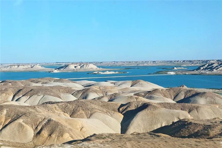 Water Yardang of Ulungur Lake, Fuhai Sea Devil City Xinjiang Unique water yardang hills by blue Ulungur Lake, desert?lake landscape of Fuhai northern Xinjiang