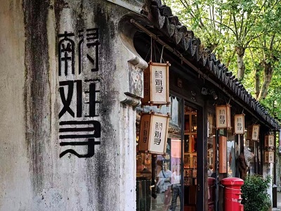 Old wall with Chinese calligraphy and traditional shop lanterns in less-crowded Nanxun Ancient Town, authentic water town landscape for private Hangzhou day tour