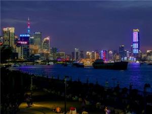 Glowing Lujiazui skyscrapers and Oriental Pearl Tower at night along Huangpu River, iconic Shanghai city view