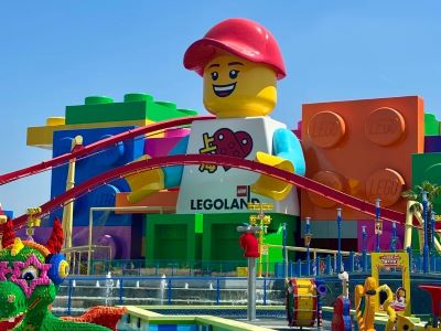 Bright exterior view of Shanghai Legoland with giant Lego figure landmark