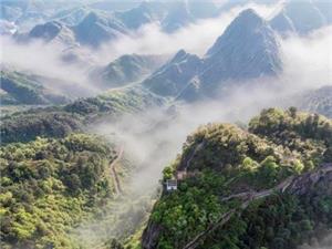 View of Qiyun Mountain layered green peaks wrapped in soft morning mist