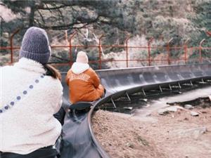 Visitors riding the fun downhill slide at Mutianyu Great Wall scenic area