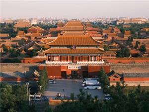 Overlooking the grand ancient Forbidden City complex with golden glazed tile roofs and red palace walls