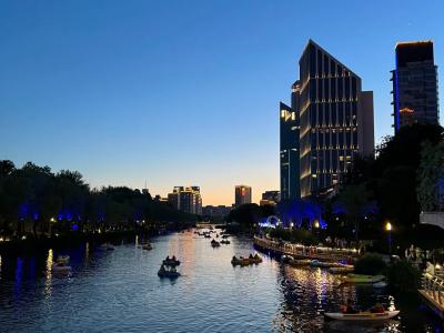  Beijing Liangma River dusk city view with paddle boats modern high-rise buildings riverside leisure tour