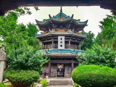 Ancient multi-layered Shengxin Pavilion surrounded by green foliage in Great Mosque Xi'an