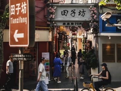 Entrance gate of Tianzifang, famous ancient alley tourist spot in Shanghai, pedestrians and street sign